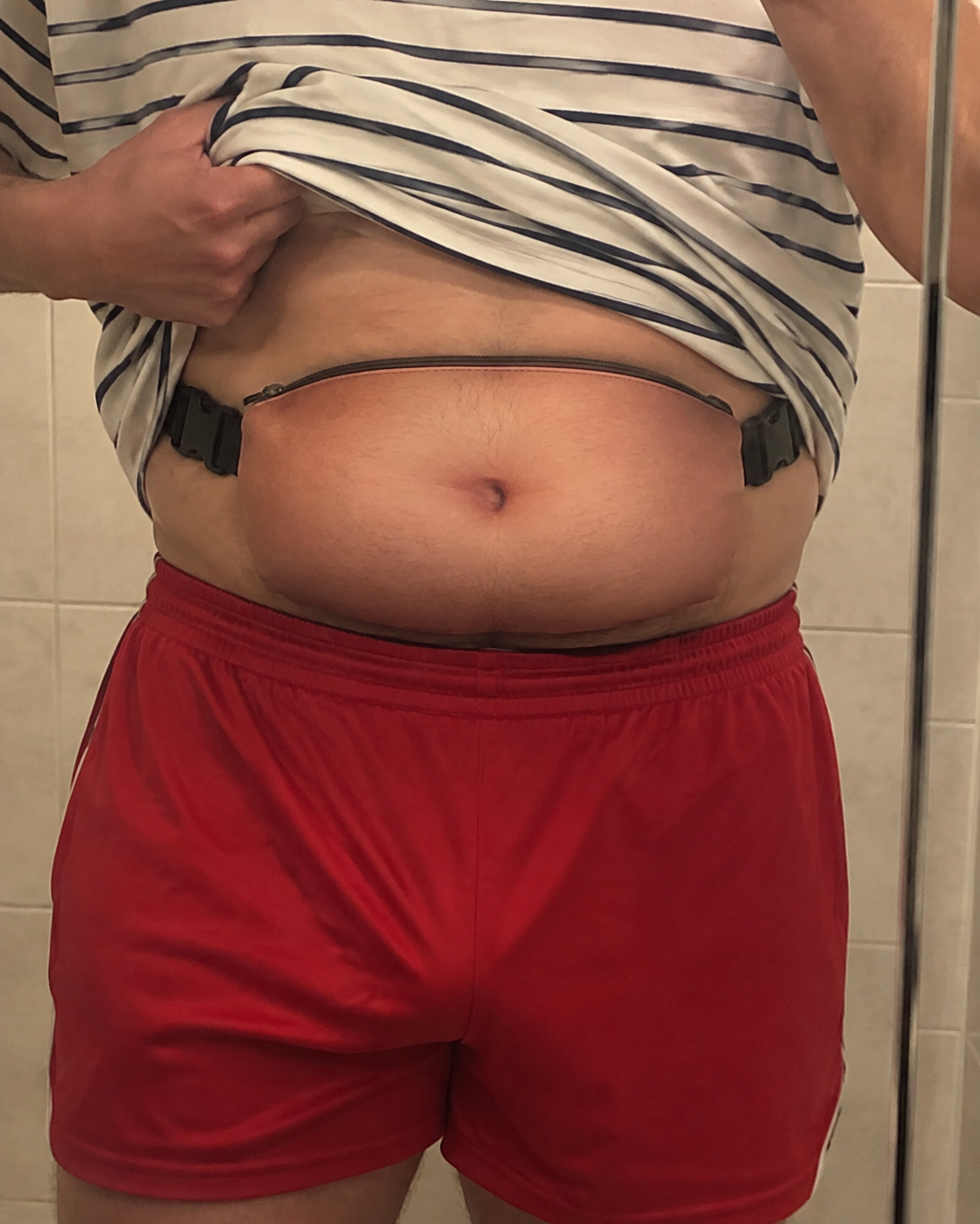 Person wearing BellyBuddy novelty belt bag outdoors